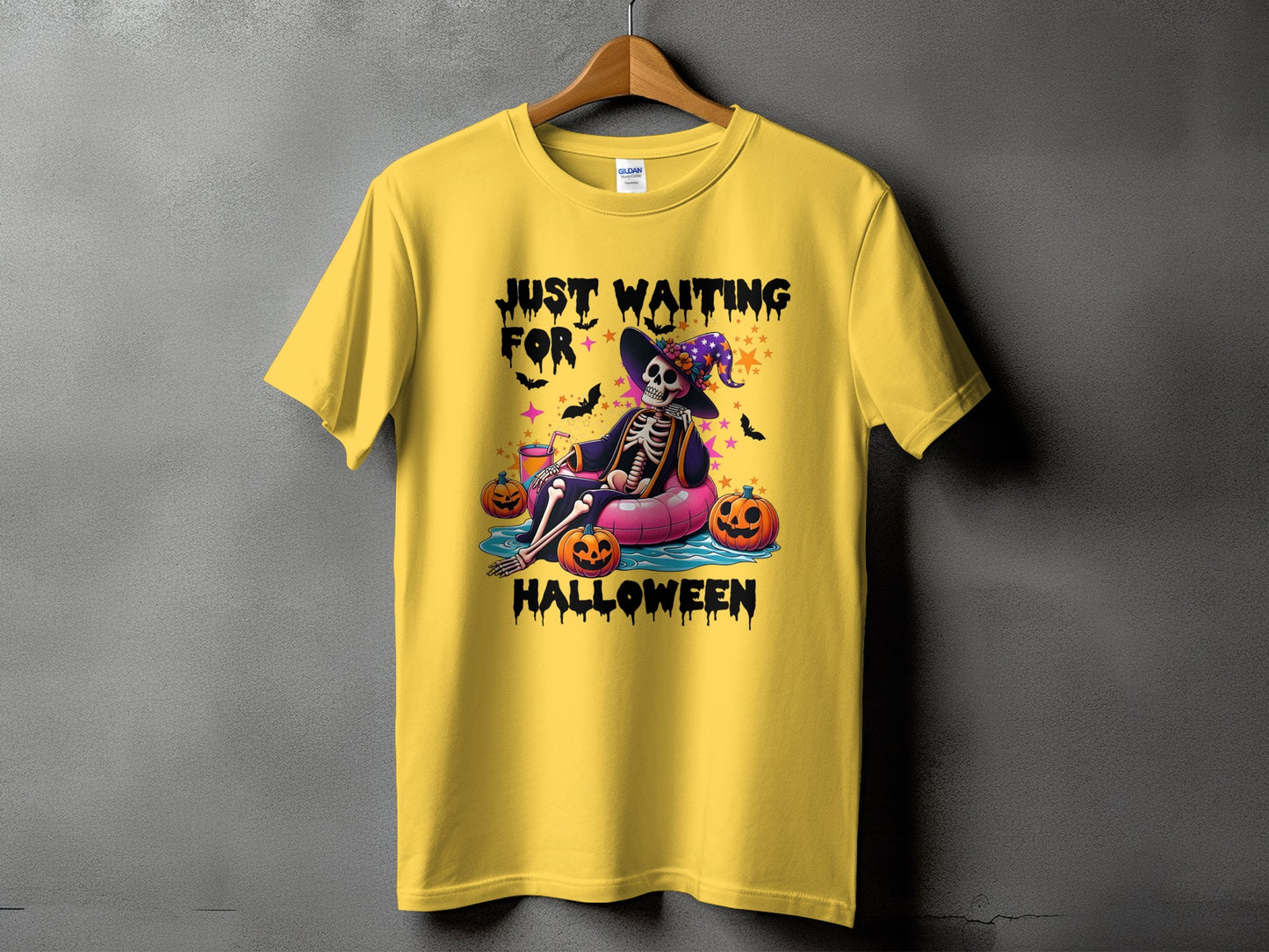 Yellow t-shirt with skeleton graphic saying "Just Waiting For Halloween".