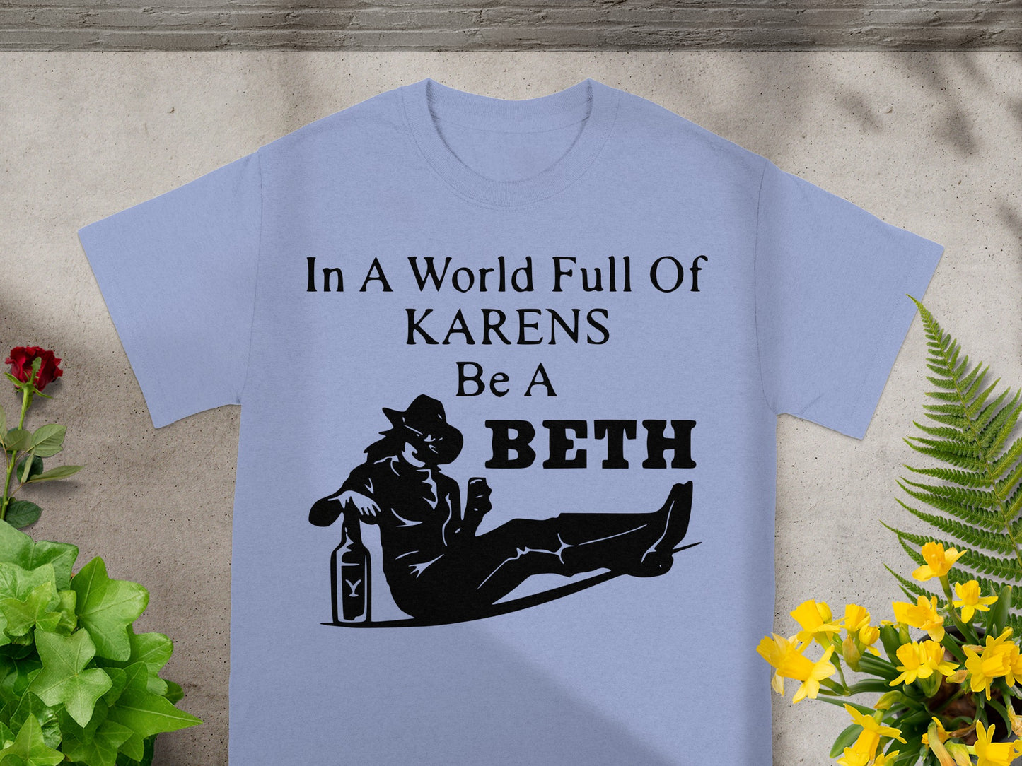 Light blue t-shirt with "In A World Full Of KARENS Be A BETH" text and graphic.