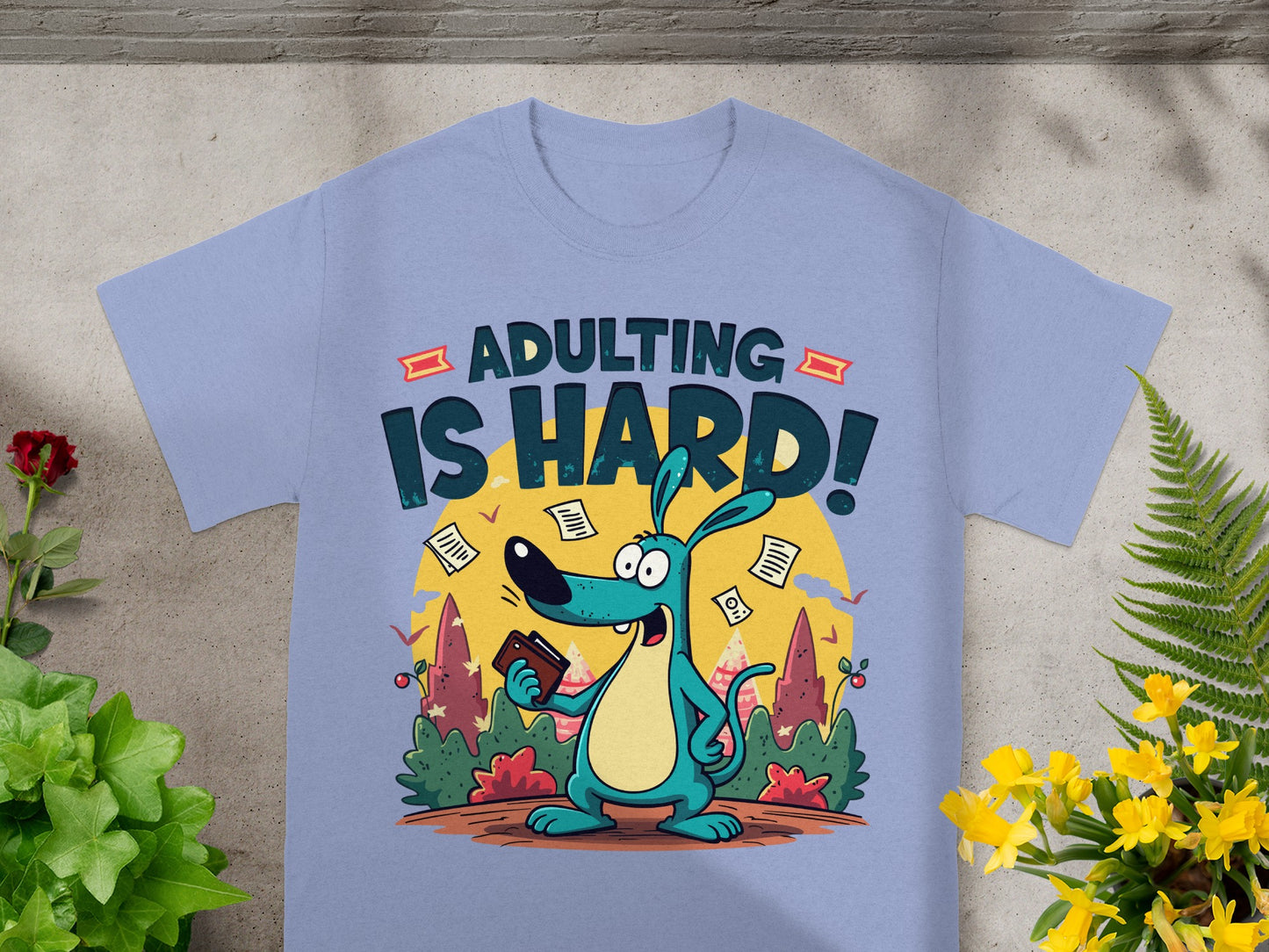 Blue t-shirt with a cartoon dog and the text "ADULTING IS HARD!"