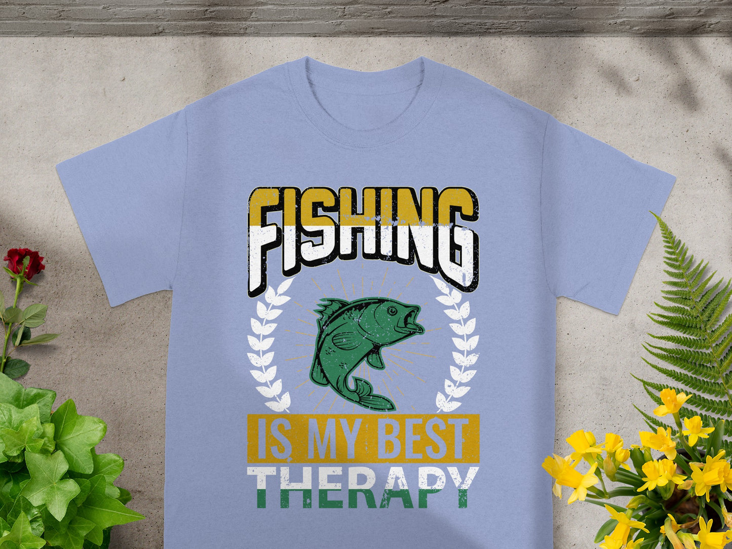Light blue t-shirt with "FISHING IS MY BEST THERAPY" text and a green bass graphic.