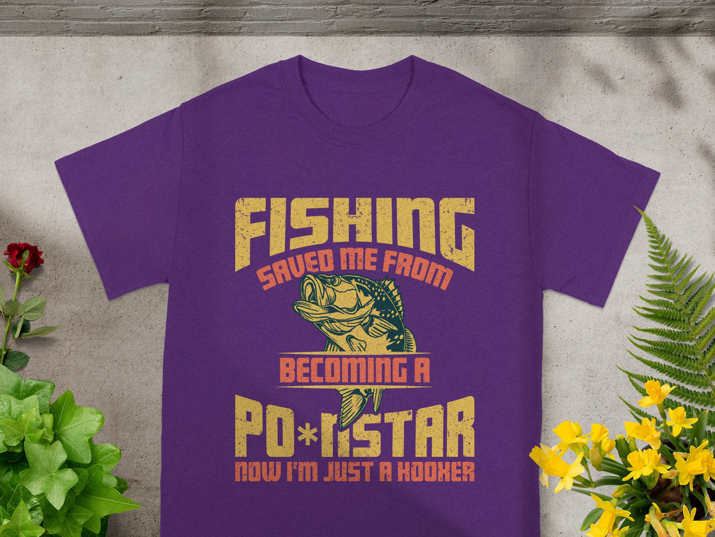 Purple t-shirt with text "Fishing saved me from becoming a pop star, now I'm just a hooker."