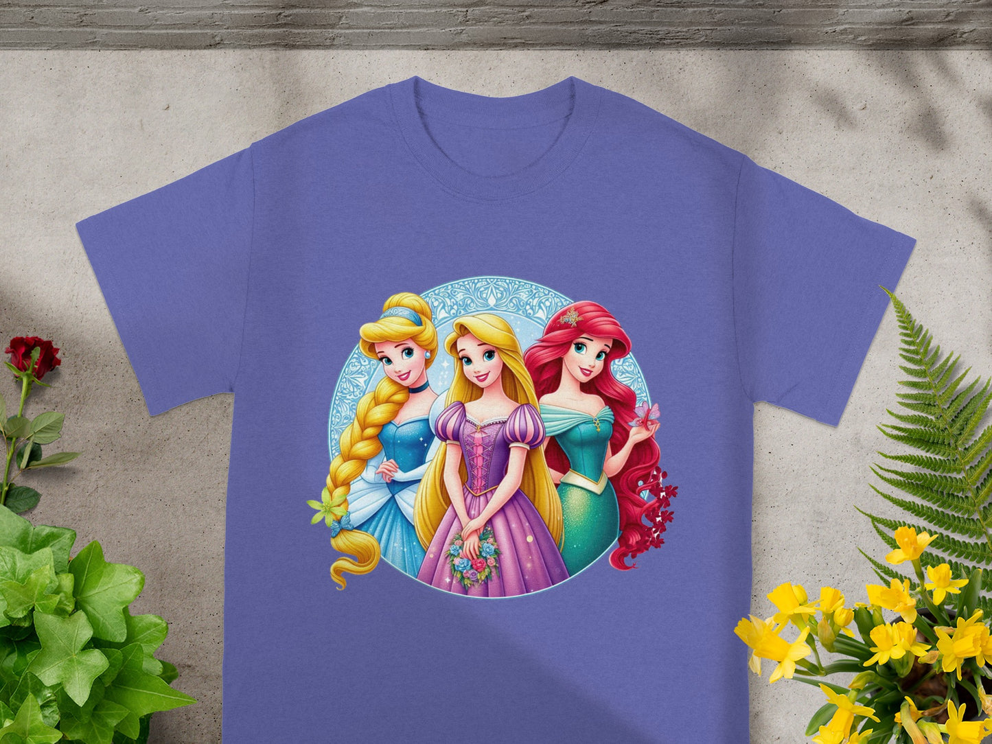 Three Disney princesses: Rapunzel, Cinderella, and Ariel, on a t-shirt.