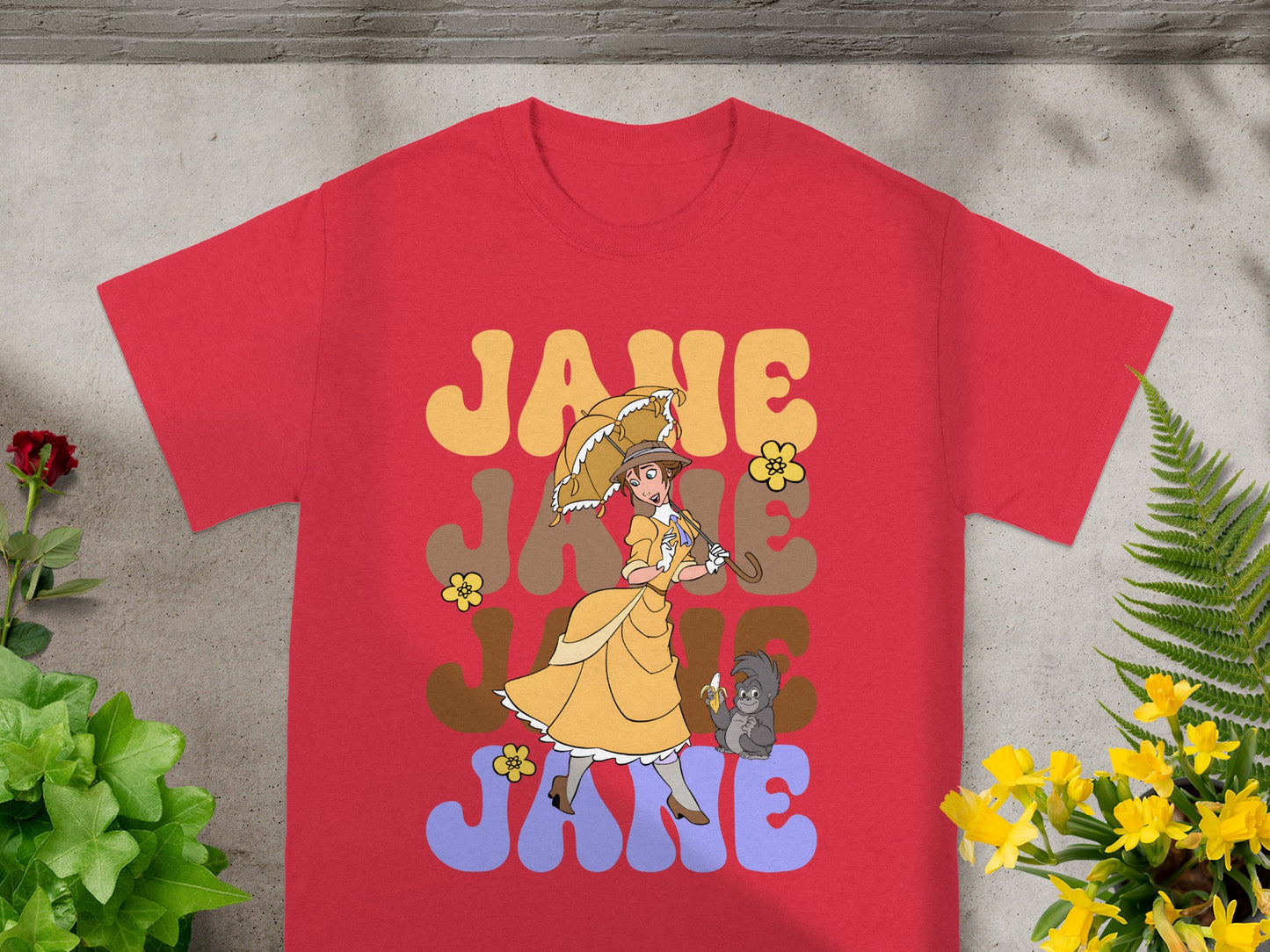Red t-shirt with "JANE" text and woman with umbrella and monkey graphic.