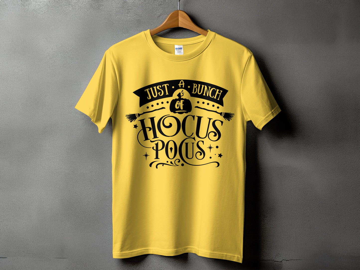Yellow t-shirt with black "Just A Bunch of Hocus Pocus" graphic and broomsticks.