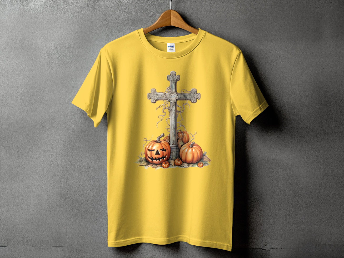 Yellow t-shirt with a cross and pumpkins graphic.