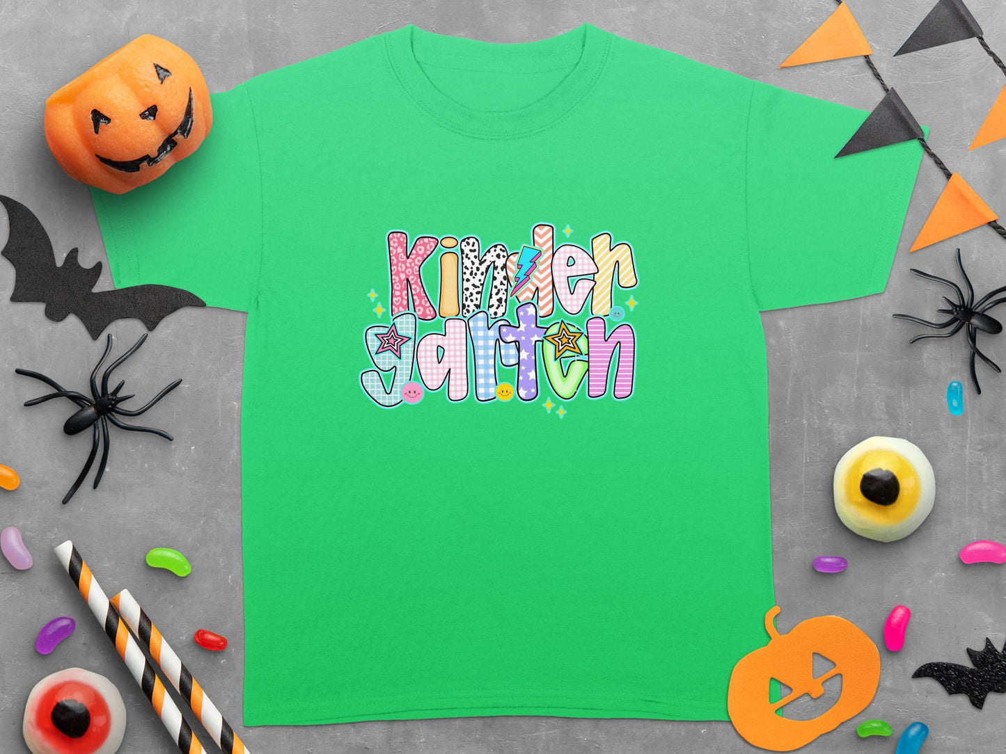 Green t-shirt with "Kinder Garten" text and Halloween decorations including a pumpkin.
