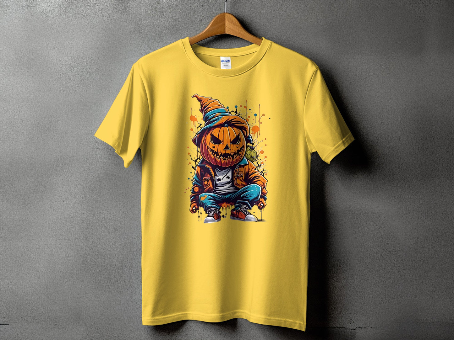 Yellow t-shirt with a graphic of a crouching cartoon pumpkin wearing a hat and jacket.