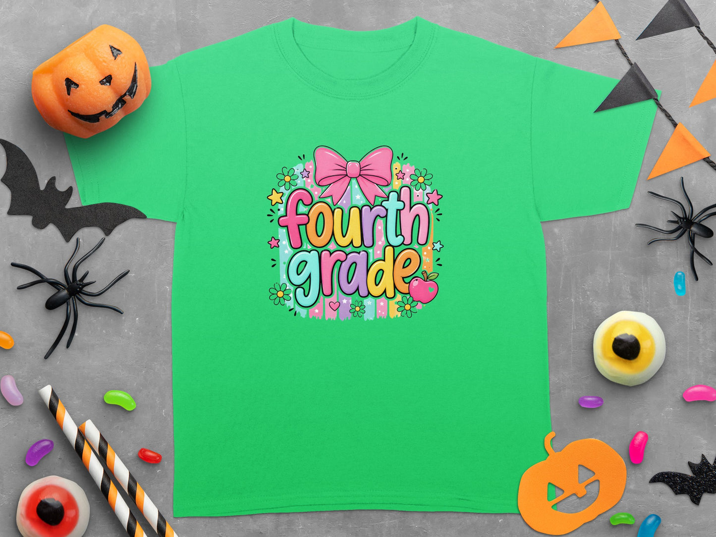 Green t-shirt with colorful "Fourth Grade" text and Halloween decorations.