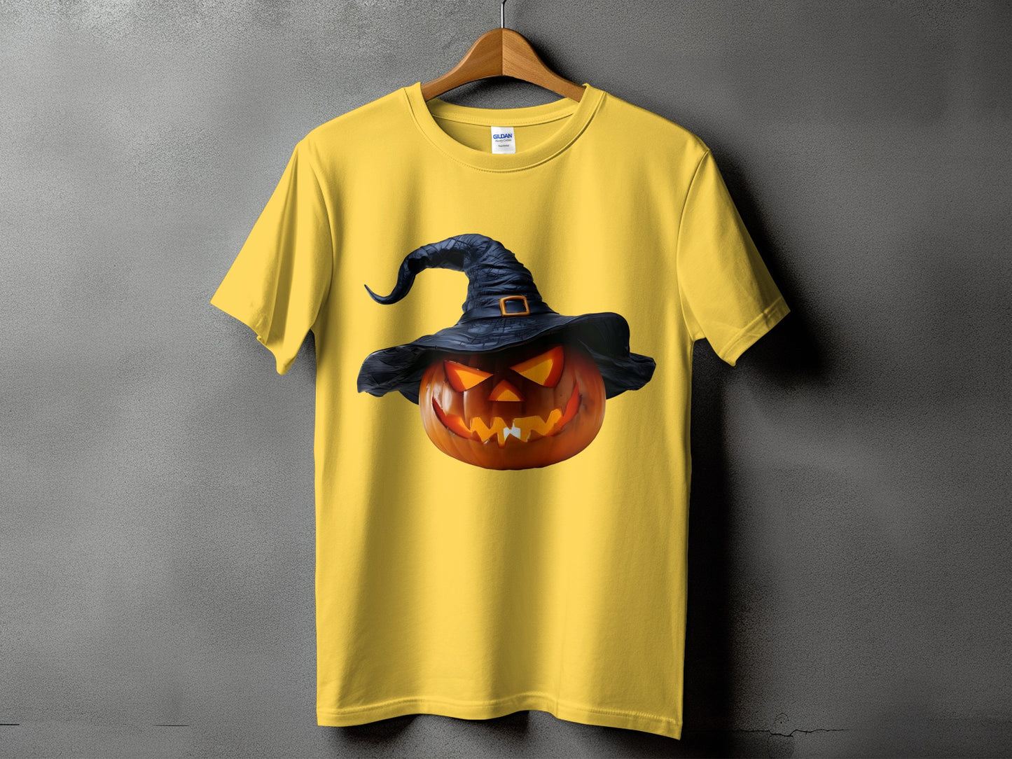 Yellow t-shirt with a jack-o'-lantern wearing a witch hat graphic.