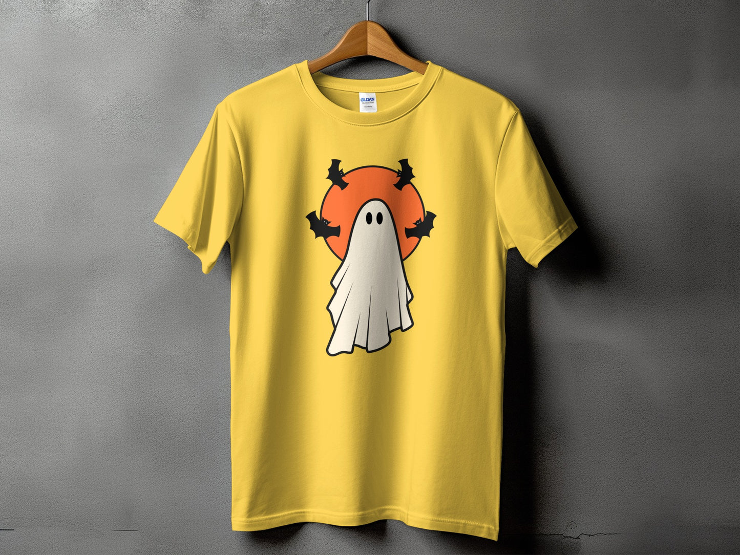 Yellow t-shirt with a Halloween ghost design featuring bats and an orange circle.
