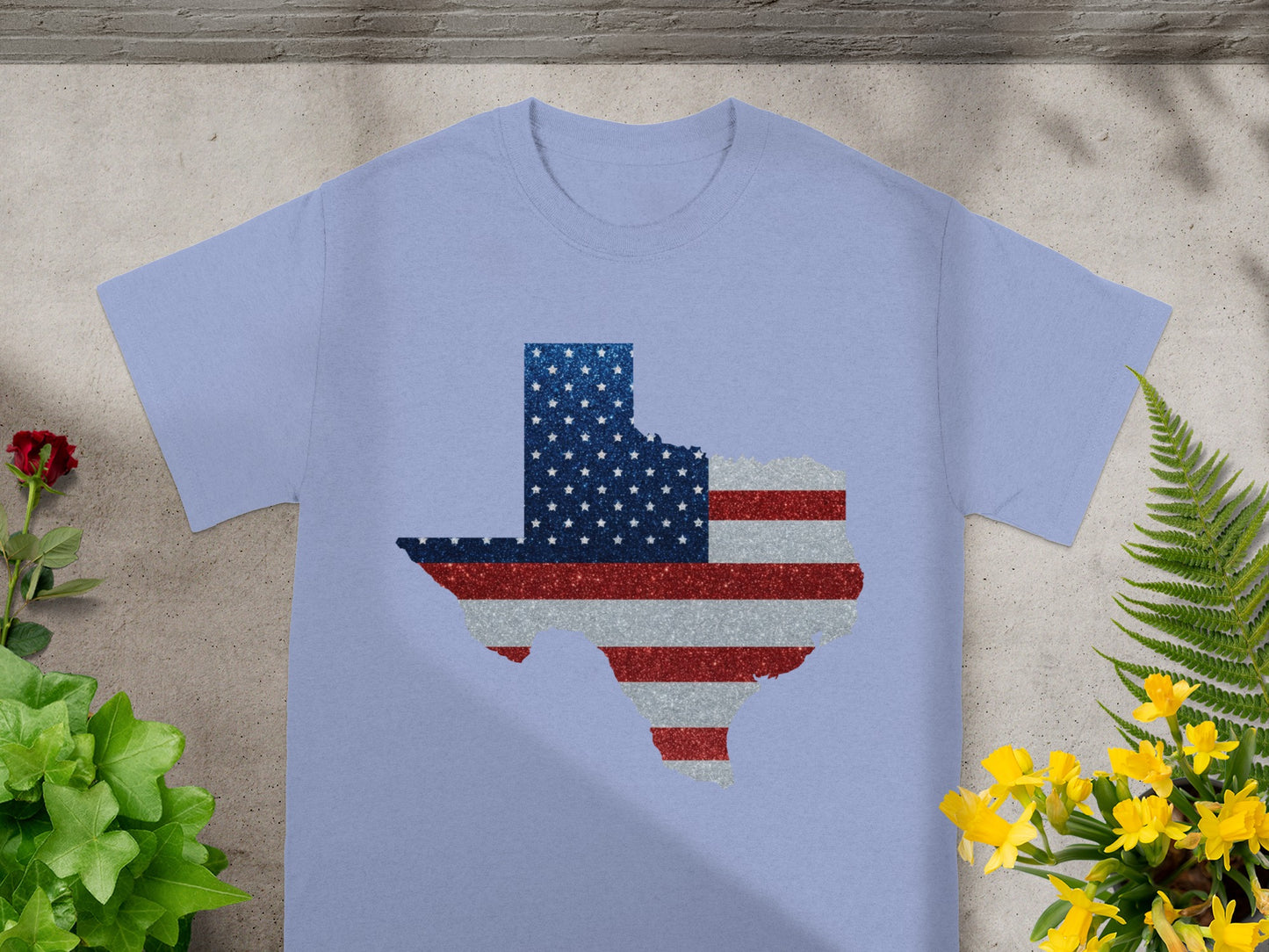 Light blue t-shirt with a Texas shape graphic in American flag colors.