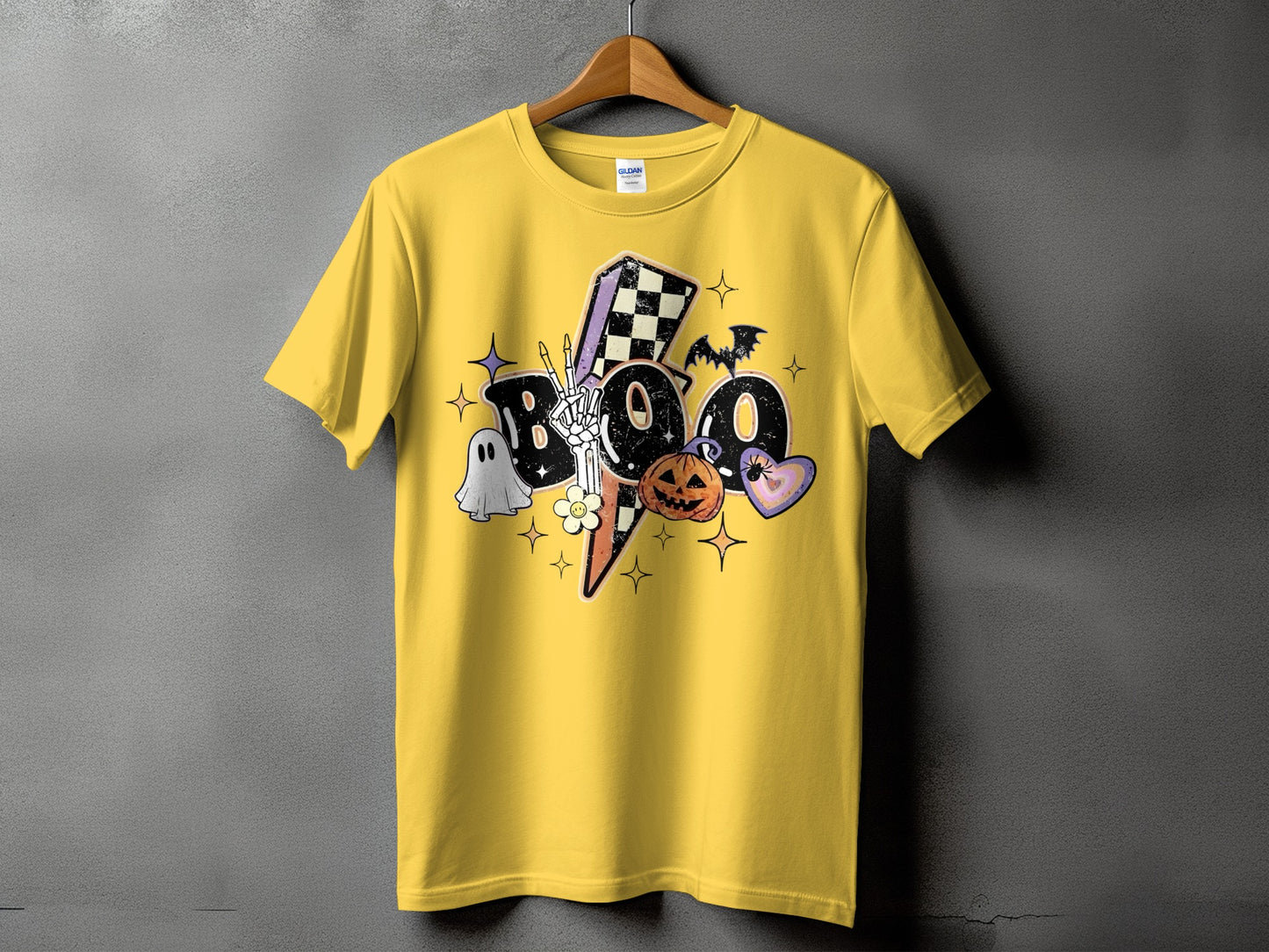 Yellow t-shirt with a "Boo" Halloween graphic featuring a ghost, pumpkin, and bat.