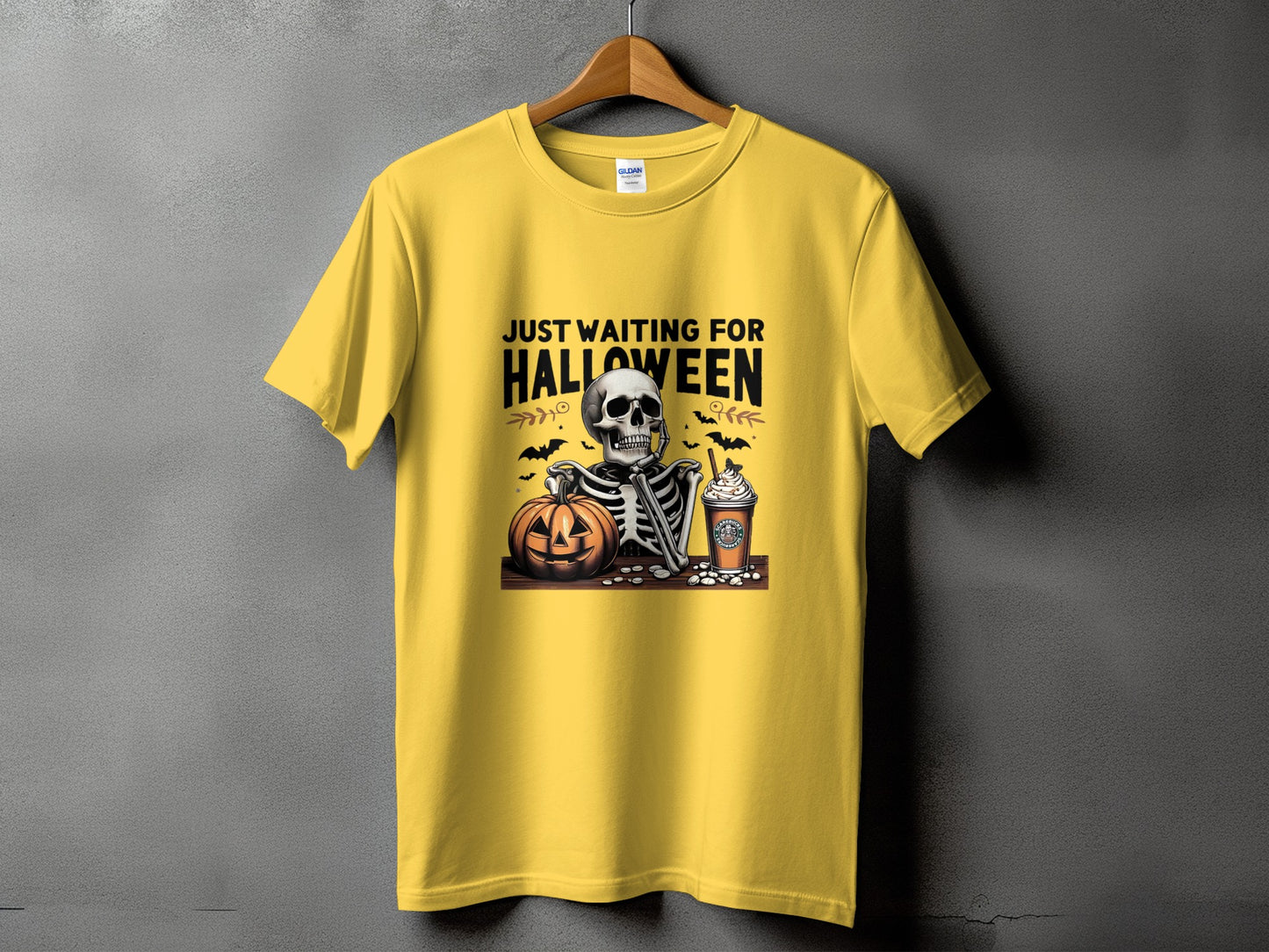 Yellow t-shirt with skeleton, pumpkin, and coffee graphic and "Just Waiting For Halloween" text.