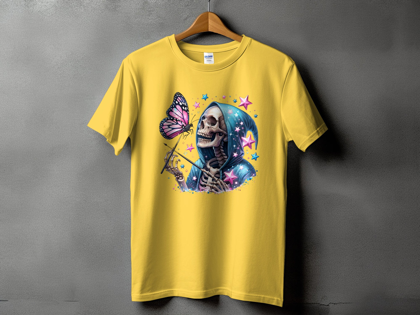 Yellow t-shirt with a skeleton in a blue hooded robe reaching for a butterfly.