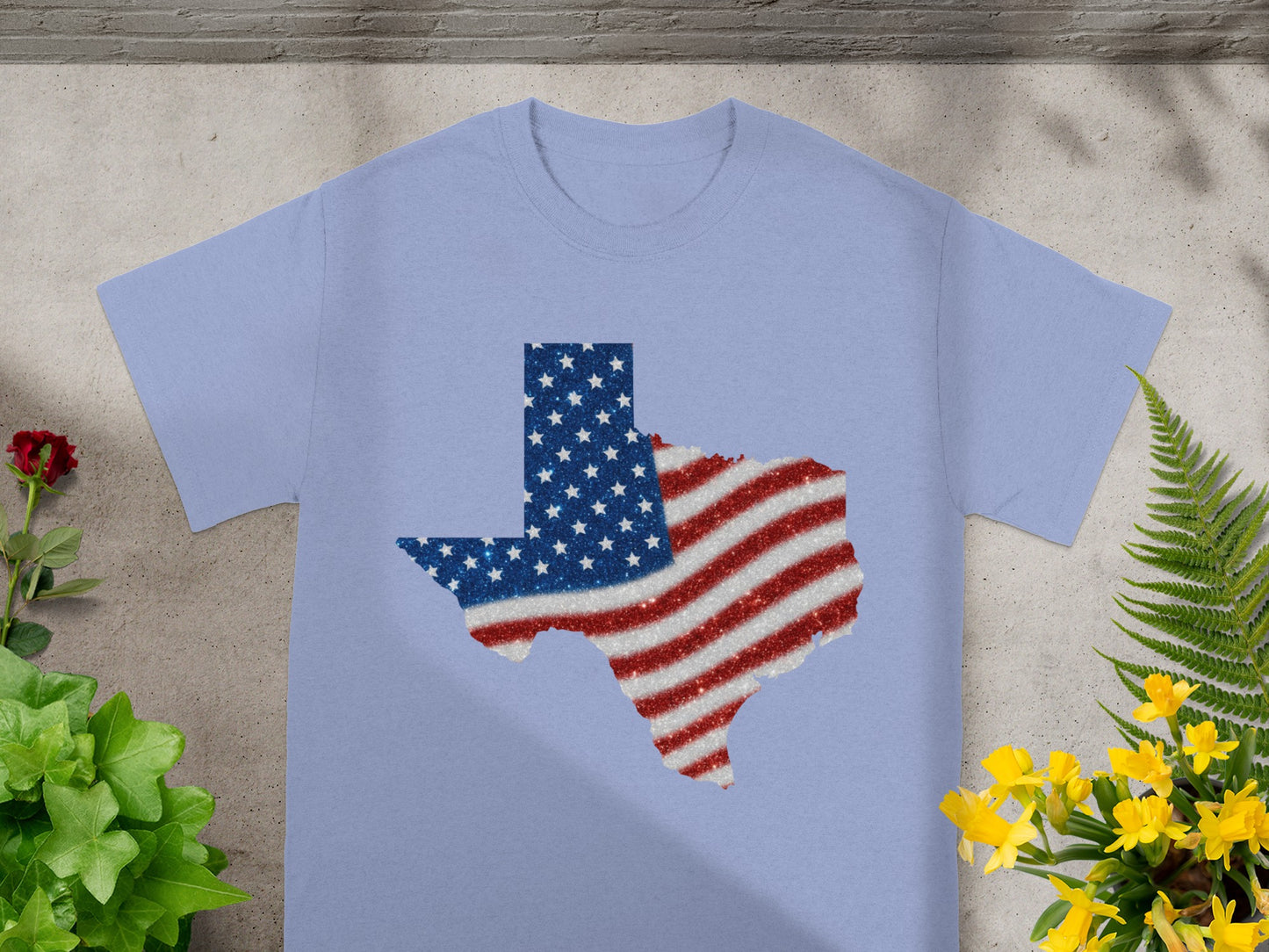 Light blue t-shirt with a glittery Texas outline filled with the American flag.