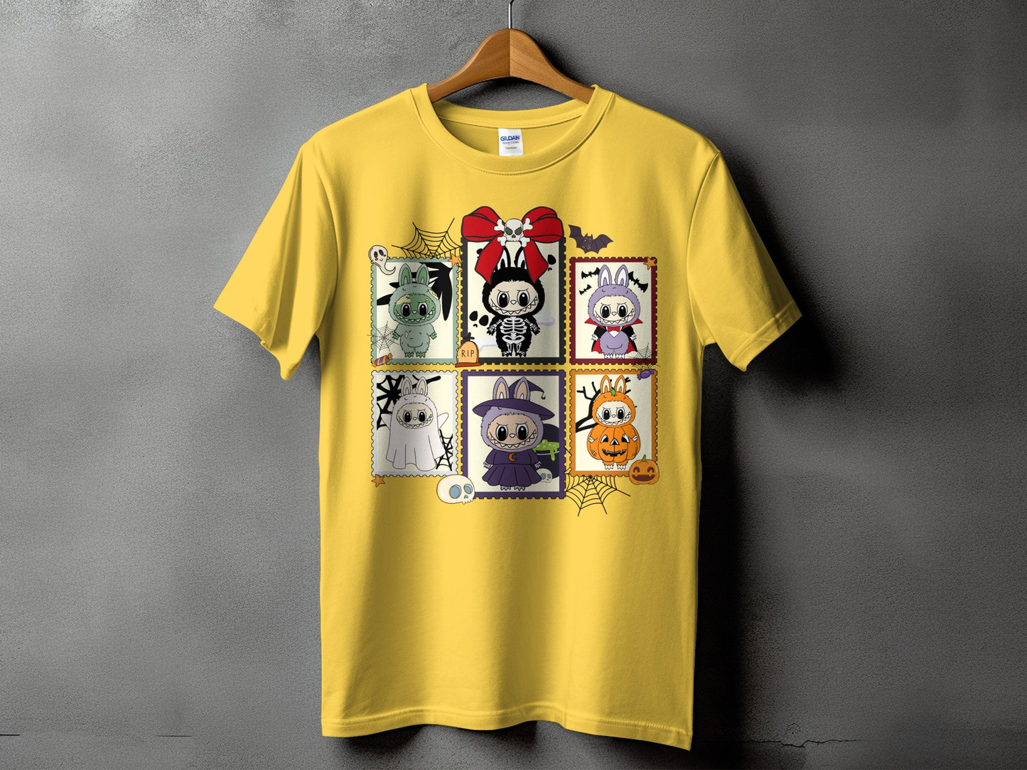 Yellow t-shirt featuring a grid of six Halloween-themed cartoon characters.