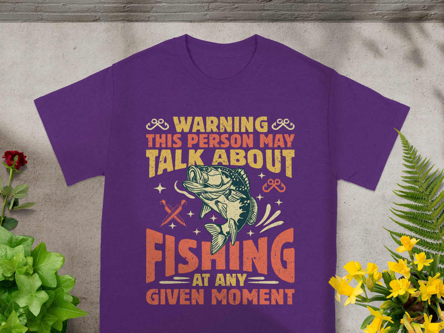 Purple t-shirt with text and fish graphic: Warning, This person may talk about fishing.