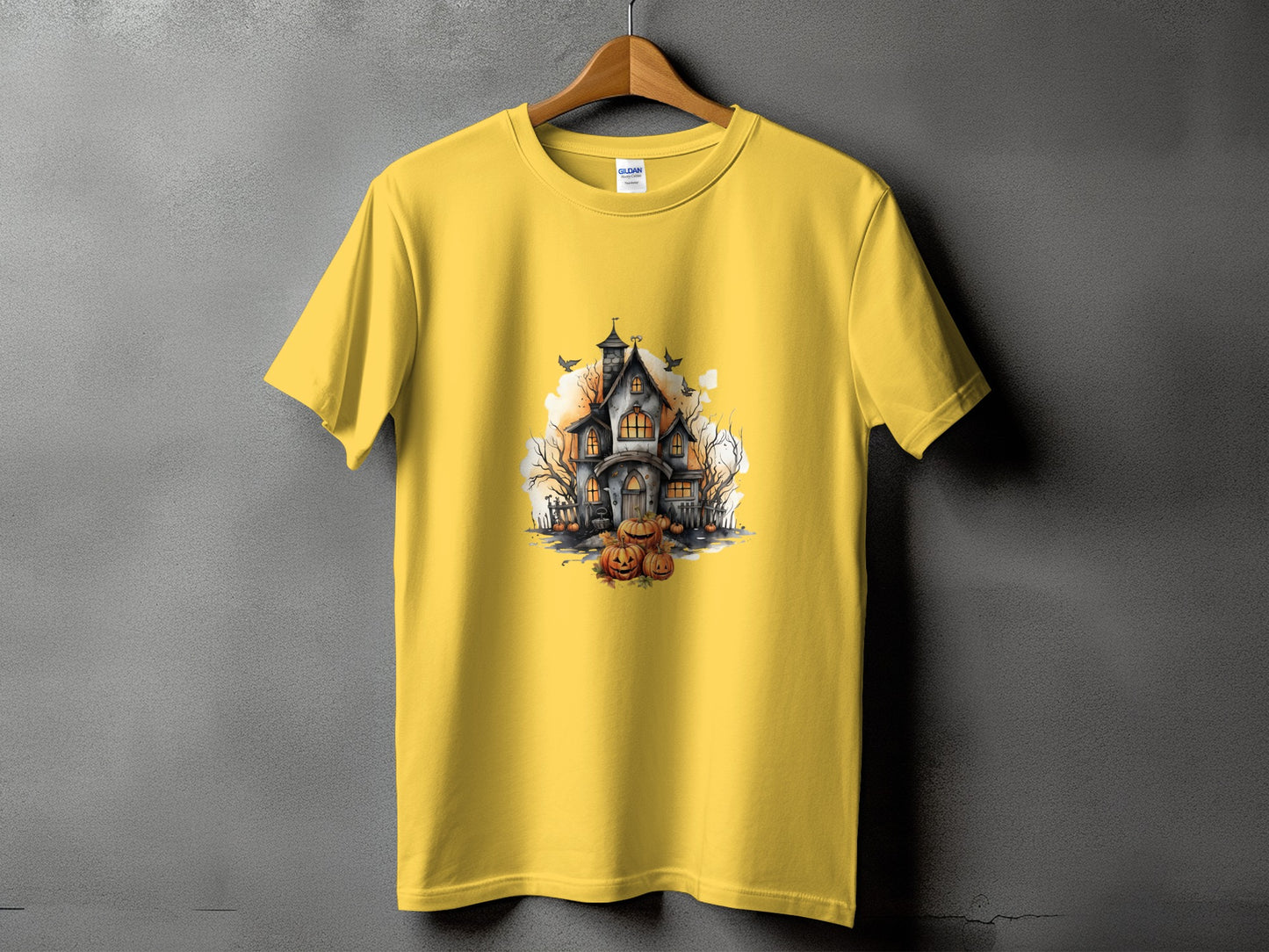 Yellow t-shirt with a haunted house and pumpkins Halloween graphic print.
