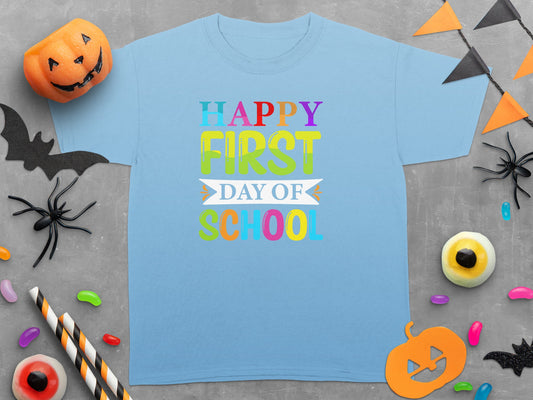 Light blue t-shirt with "Happy First Day of School" graphic and Halloween decorations.