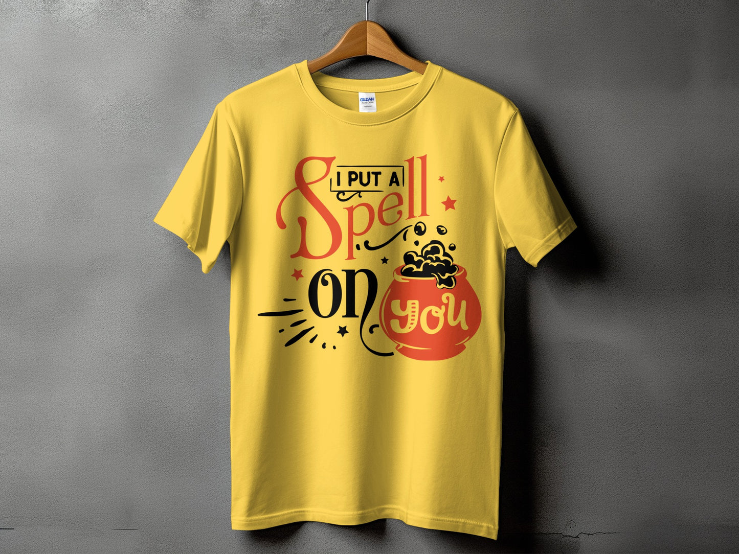 Yellow t-shirt with graphic text "I PUT A Spell on YOU" and cauldron.