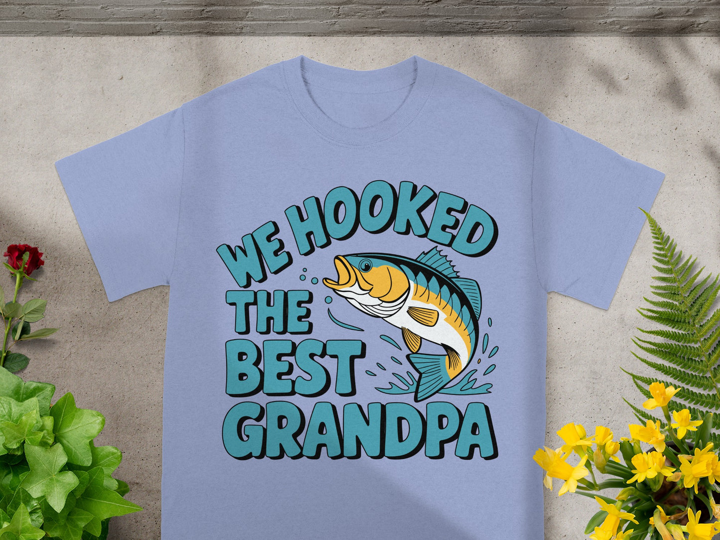 Light blue t-shirt with text "We Hooked The Best Grandpa" and a jumping fish.
