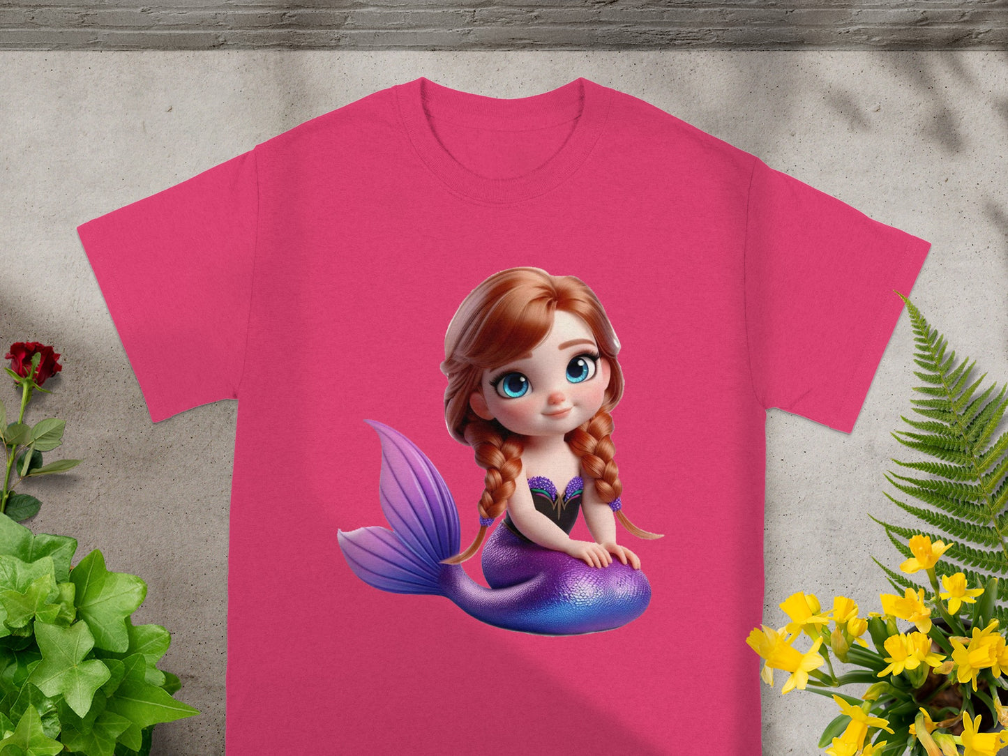 Pink t-shirt with cartoon mermaid graphic.