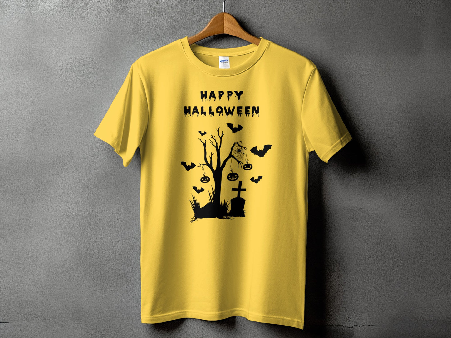 Yellow t-shirt with black Halloween graphic featuring "Happy Halloween" text and spooky tree.