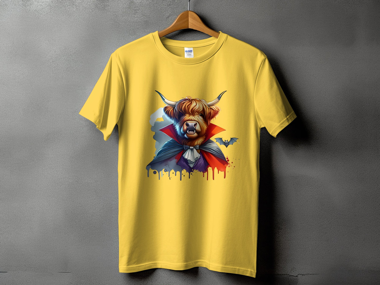 Yellow t-shirt with a Highland cow dressed as a vampire with a bat.