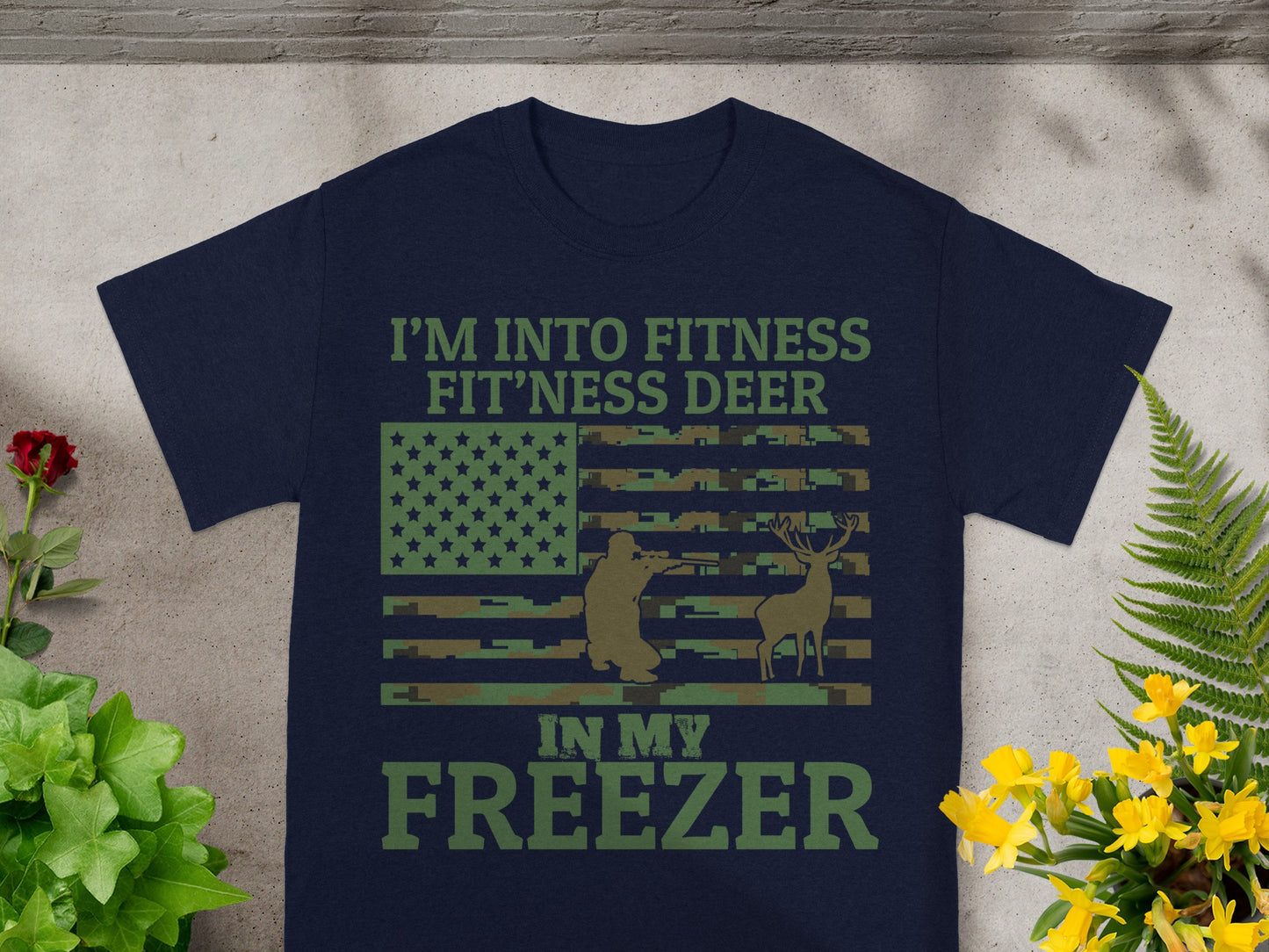 Navy t-shirt with text "I'M INTO FITNESS FIT'NESS DEER IN MY FREEZER" and a camouflage flag.