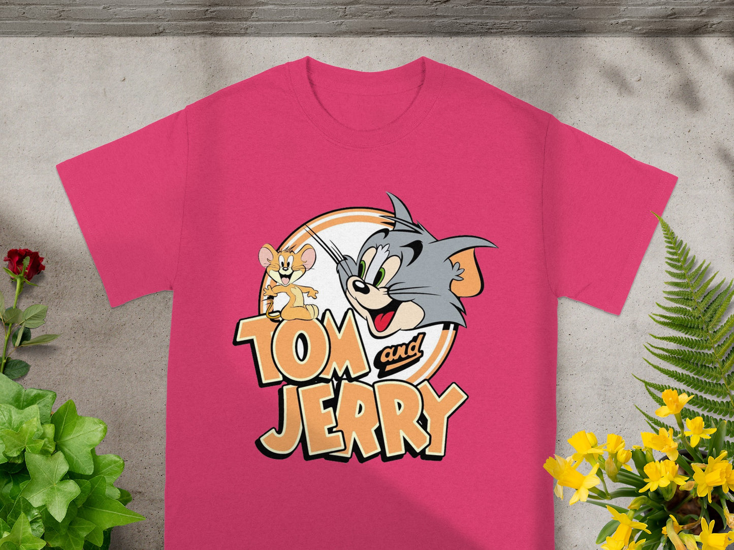 Pink t-shirt with Tom and Jerry cartoon characters in a circular graphic.