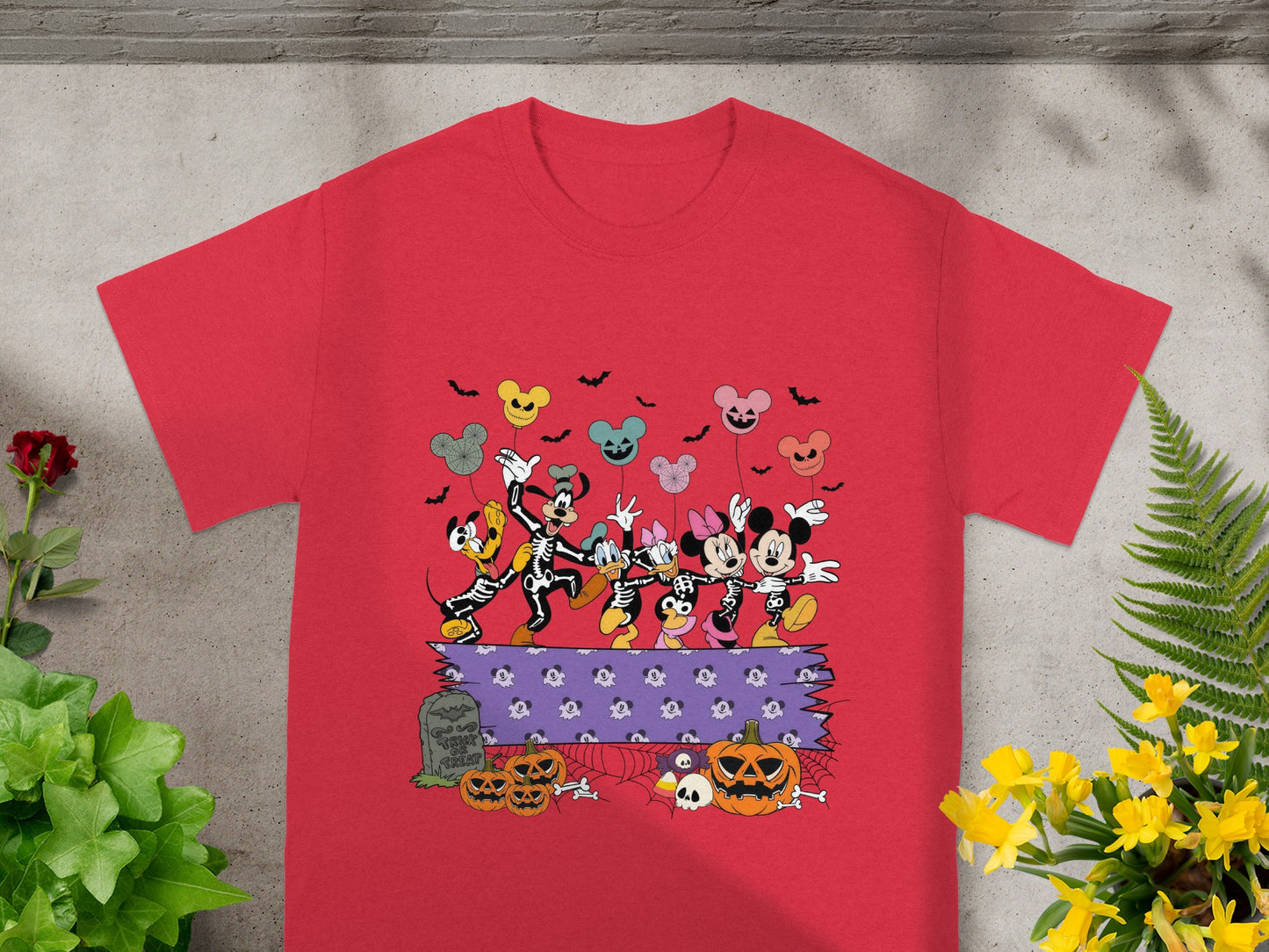 Disney characters in skeleton costumes dancing with Halloween Mickey Mouse balloons.