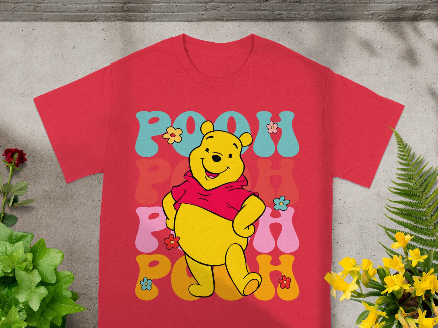 Red t-shirt with Winnie the Pooh and colorful "Pooh" text.