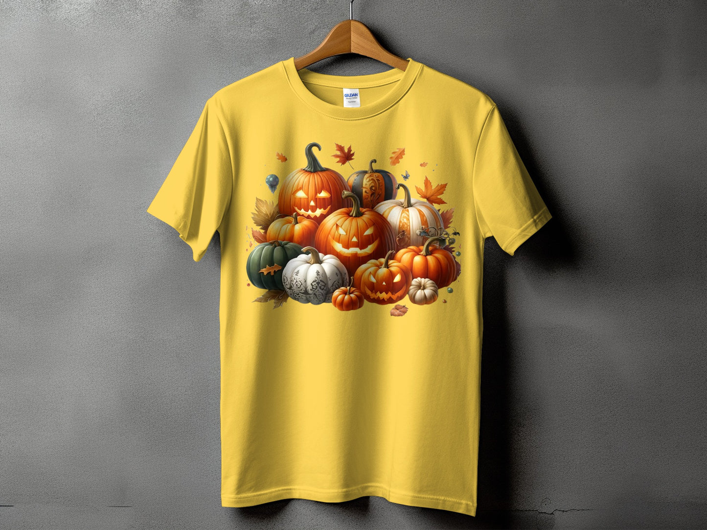 Yellow t-shirt with a pile of jack-o'-lanterns and autumn leaves graphic.