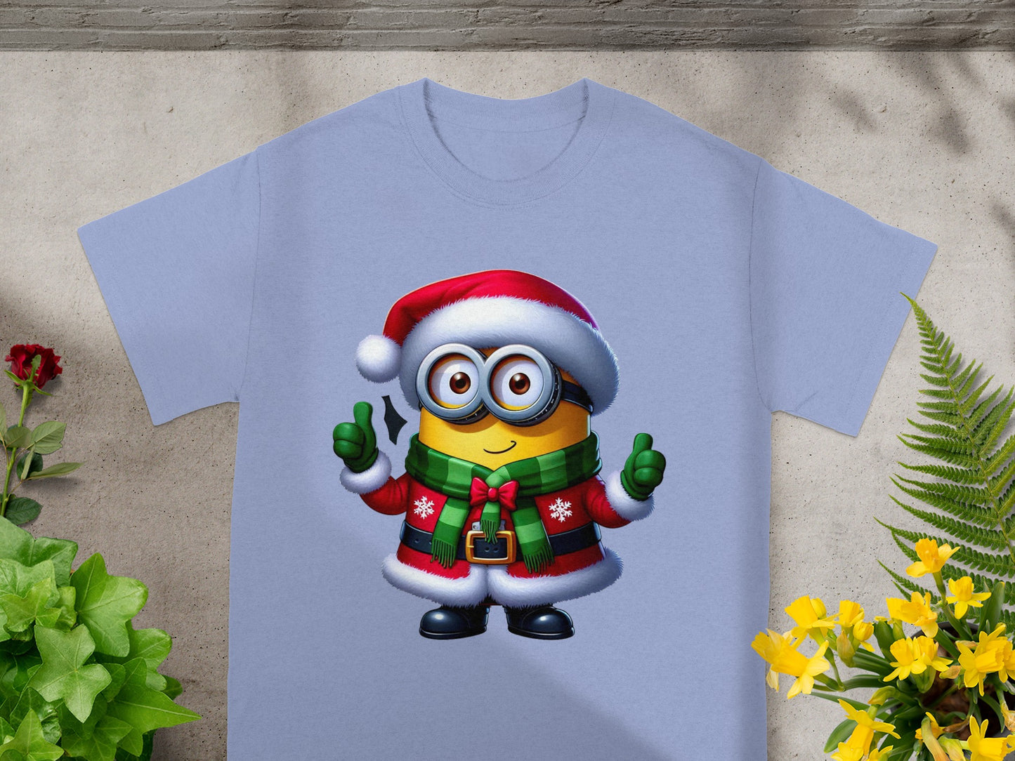 Minion wearing Santa hat and suit with green scarf, giving thumbs up.