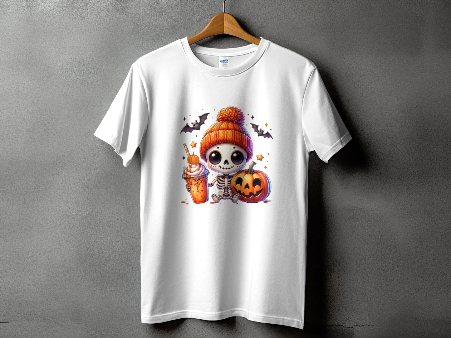 White t-shirt with Halloween skeleton, pumpkin, and coffee graphic.