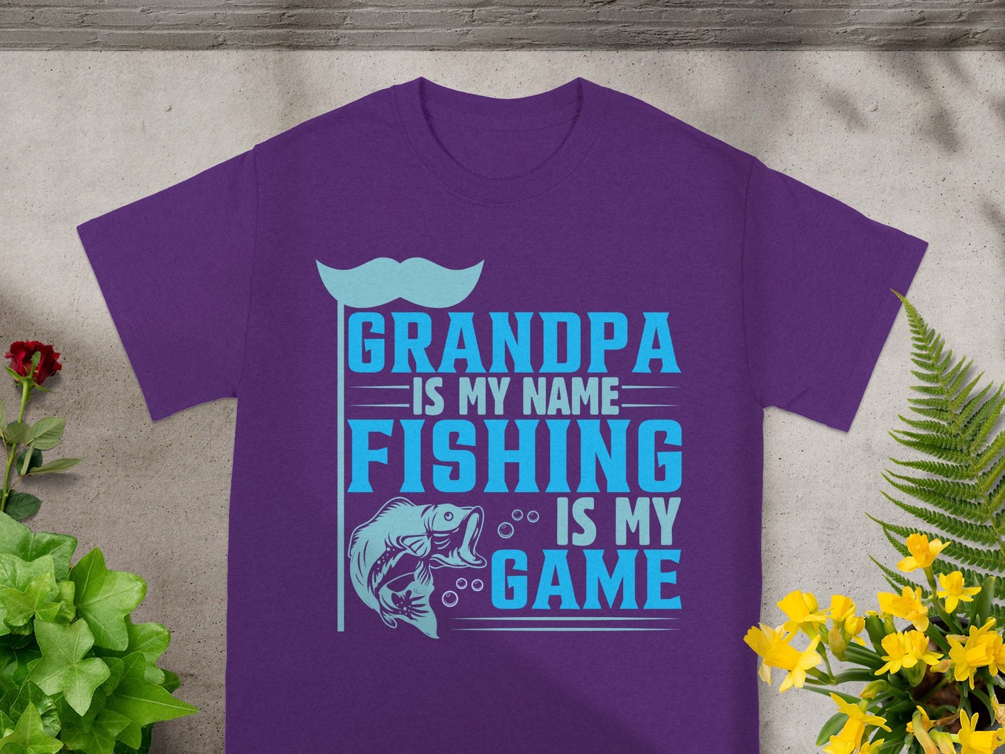 Purple t-shirt with text: Grandpa is my name, Fishing is my game.