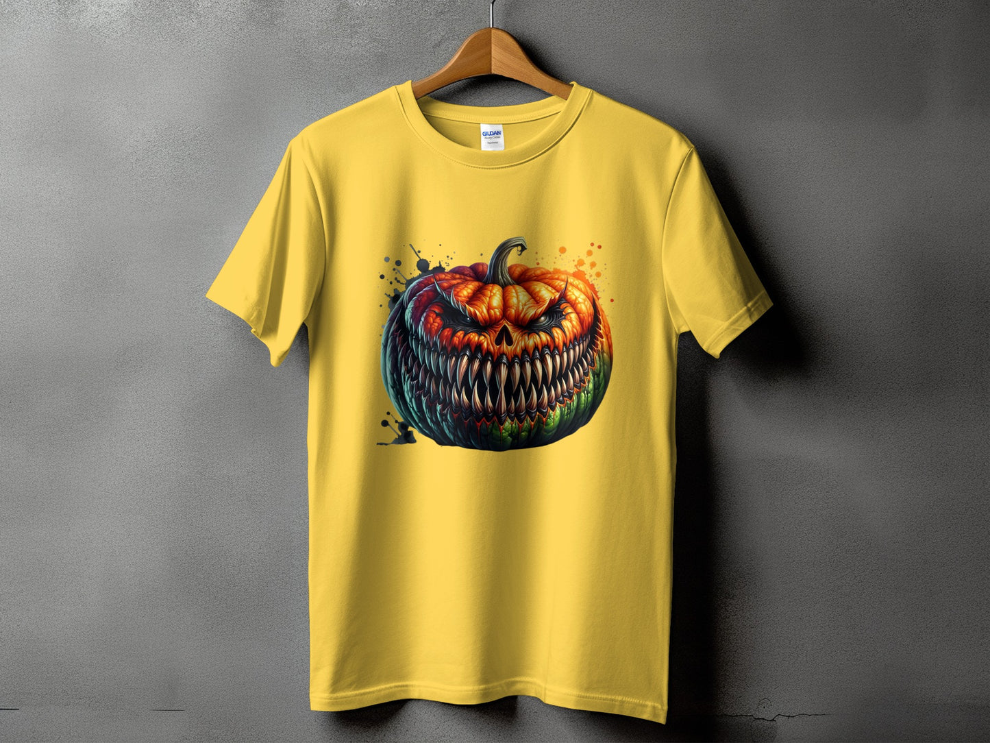 Yellow t-shirt with a monstrous, fanged jack-o'-lantern graphic with paint splatters.