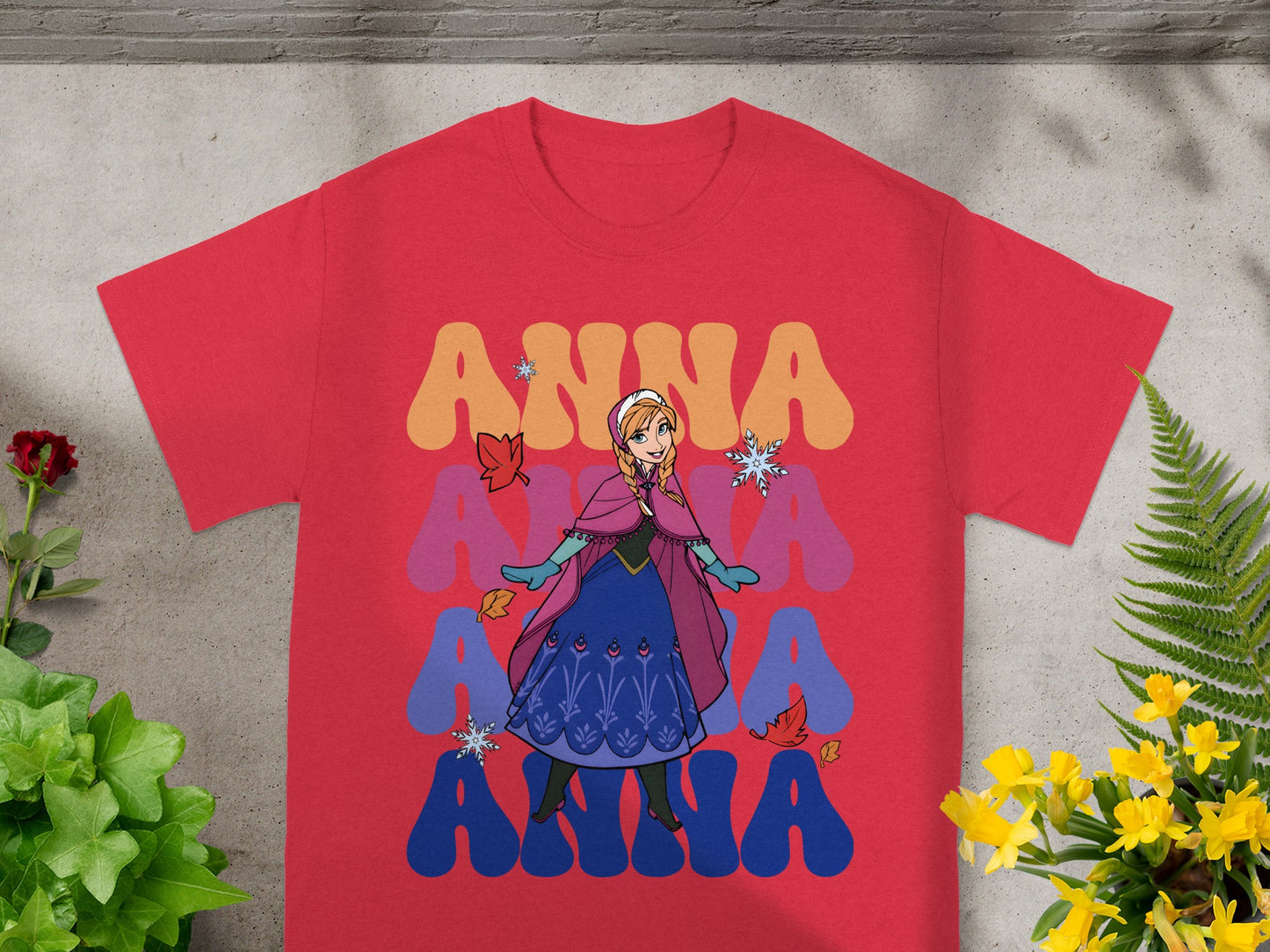 Anna from Frozen on a red t-shirt with colorful "ANNA" text.