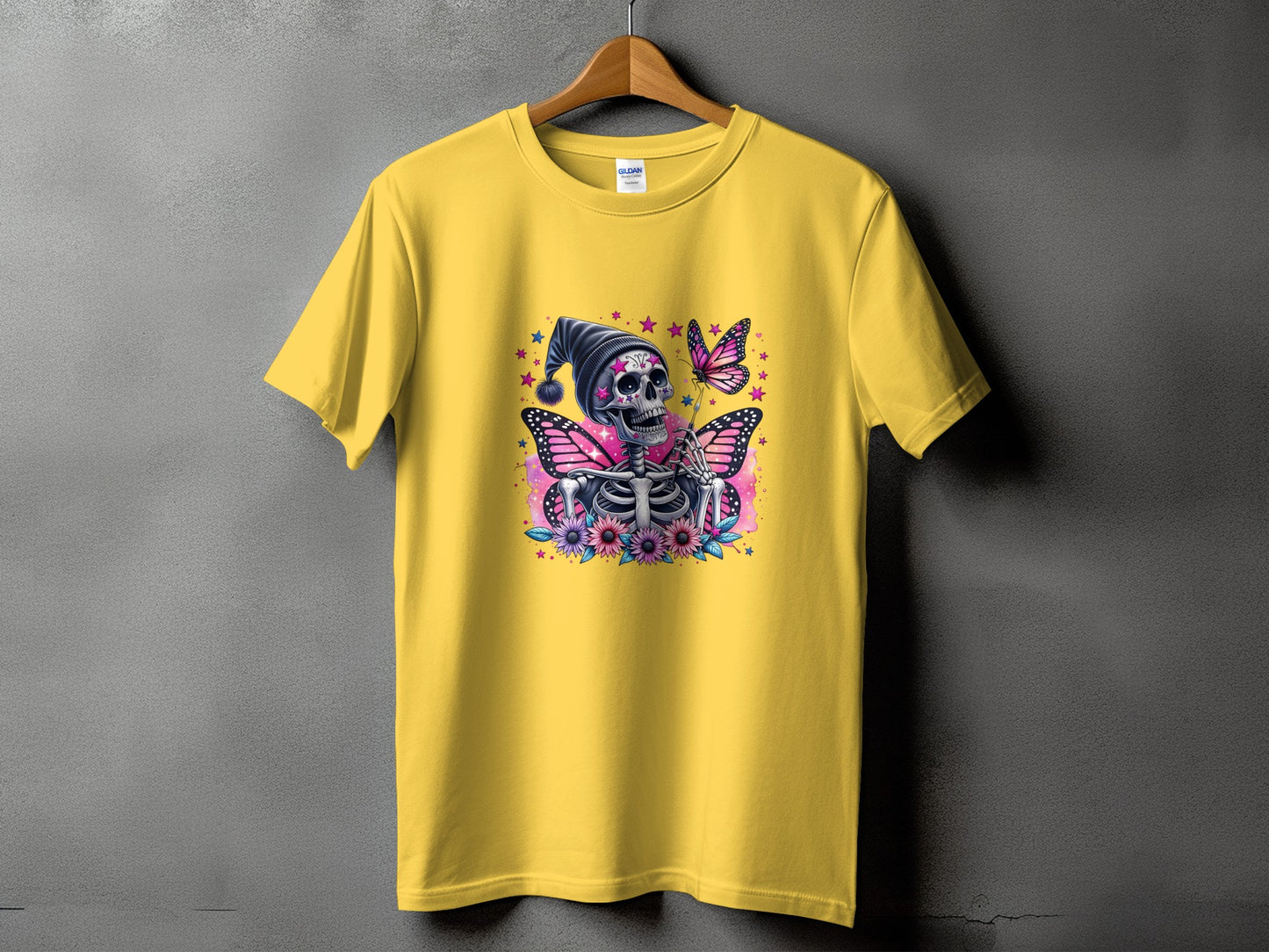 Yellow t-shirt with skeleton, butterflies, and flowers graphic on front.