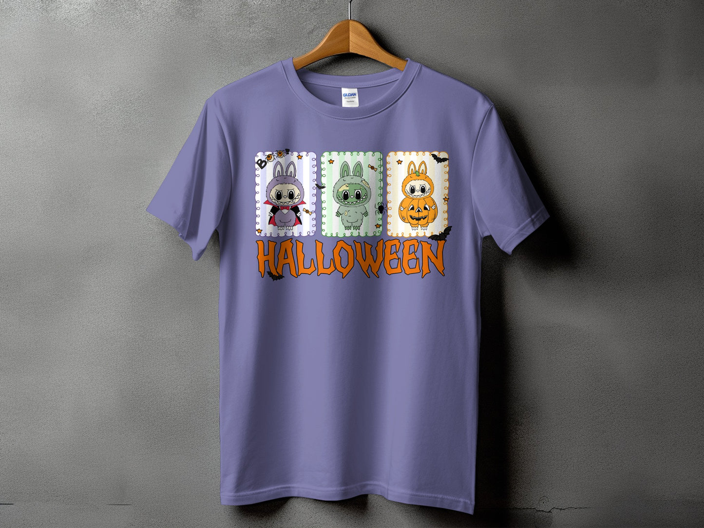 Purple t-shirt with three Halloween-themed character panels and orange text.