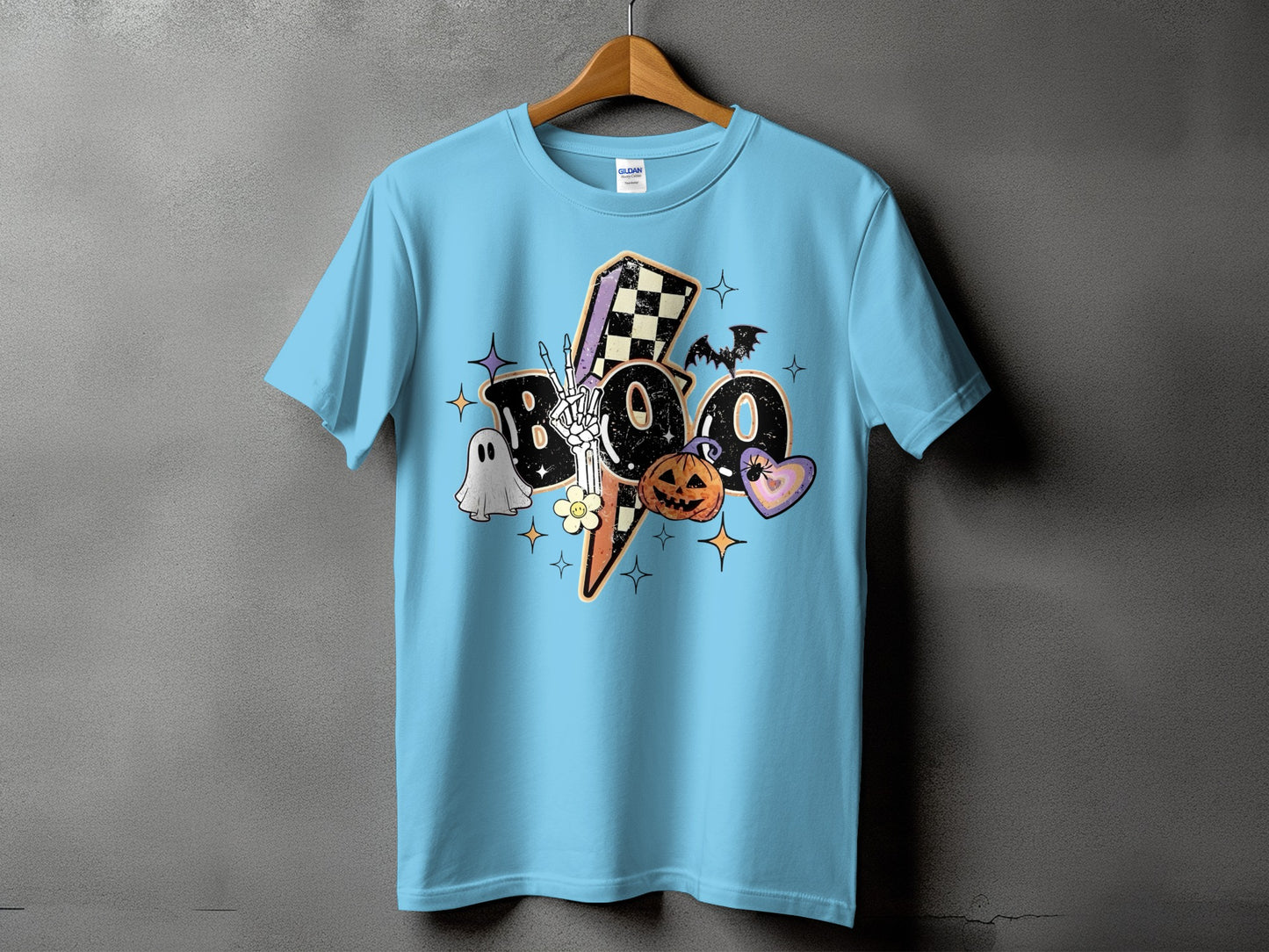 Light blue t-shirt with "Boo" design featuring ghost, skeleton hand, pumpkin, and bat.