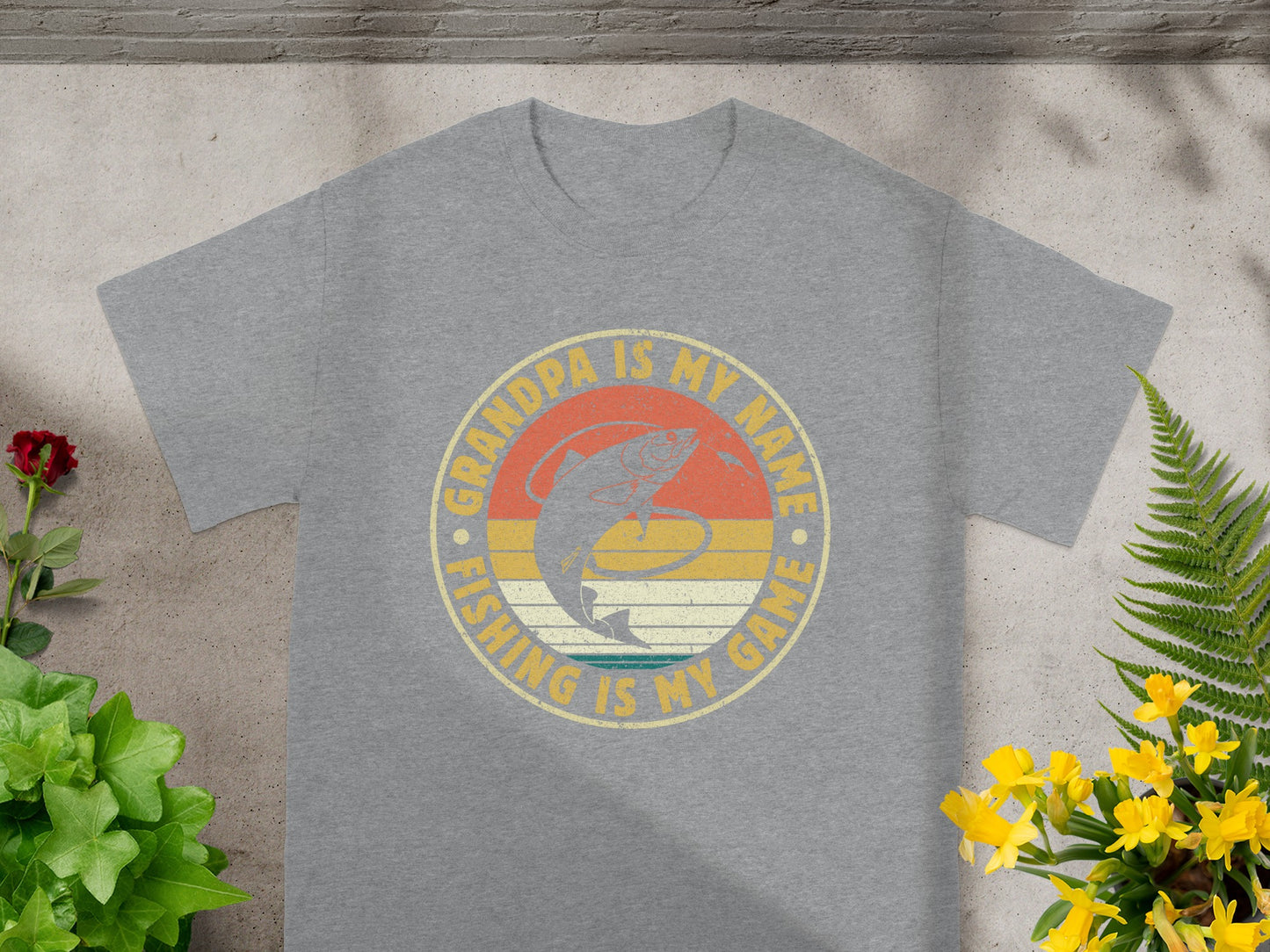 Grey t-shirt with "GRANDPA IS MY NAME FISHING IS MY GAME" text and fishing graphic.