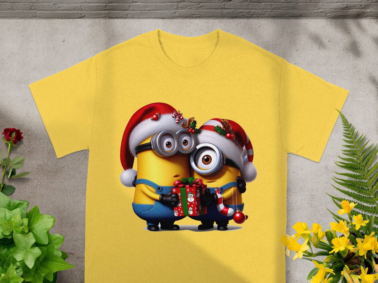Two Minions in Santa hats hug a Christmas gift and candy cane.