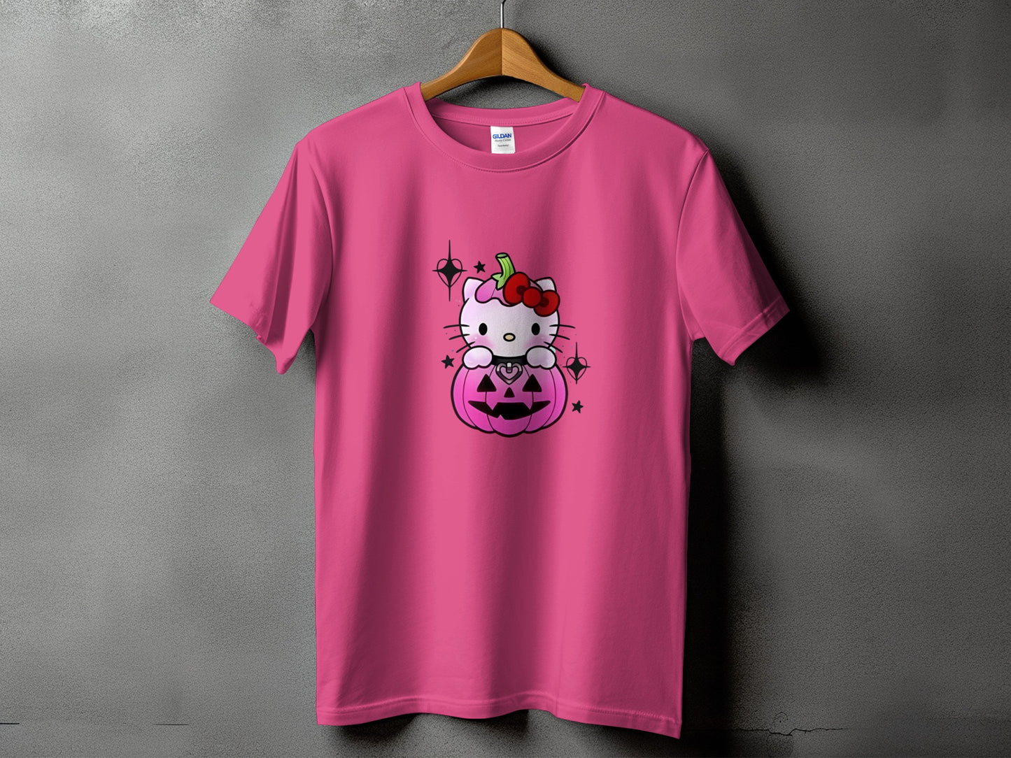 Pink t-shirt with Hello Kitty sitting in a Halloween pumpkin graphic.