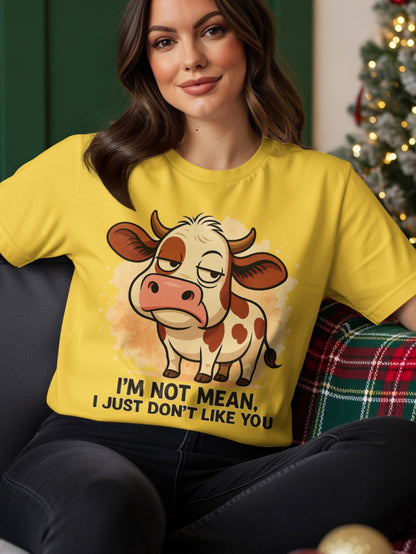 Yellow t-shirt with a grumpy cartoon cow and text "I'M NOT MEAN, I JUST DON'T LIKE YOU."