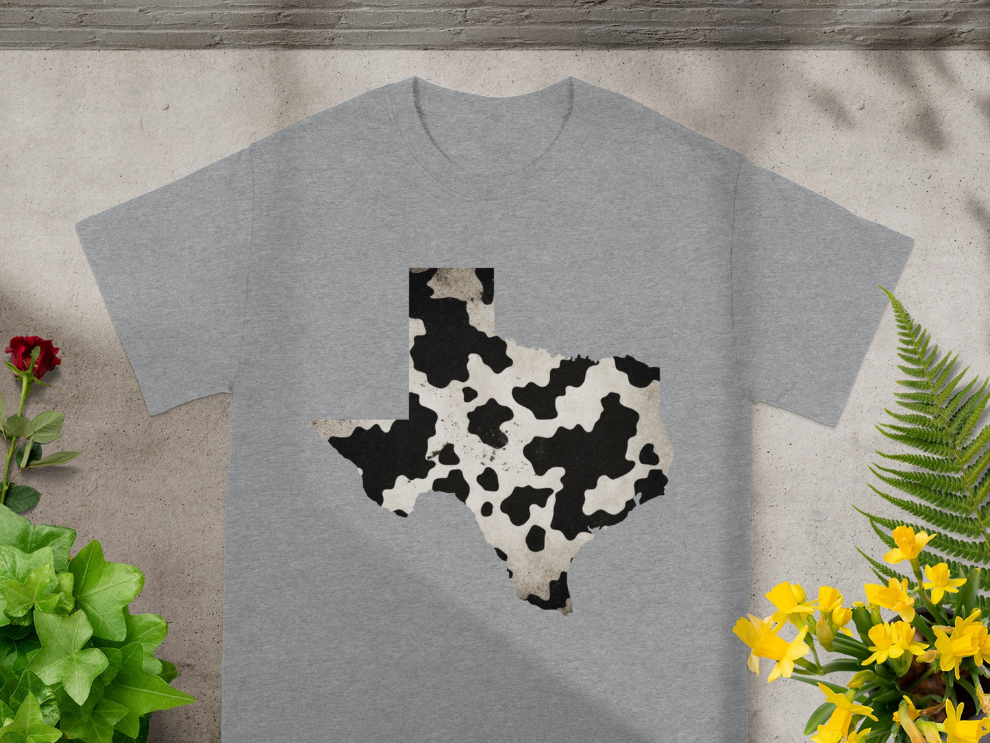Grey t-shirt featuring a Texas map design with a cow print texture.