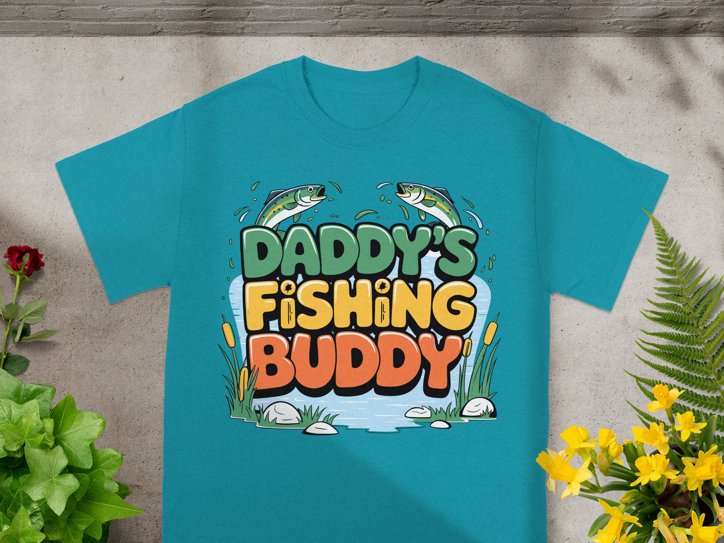 Teal t-shirt with "Daddy's Fishing Buddy" text, fish, and water.