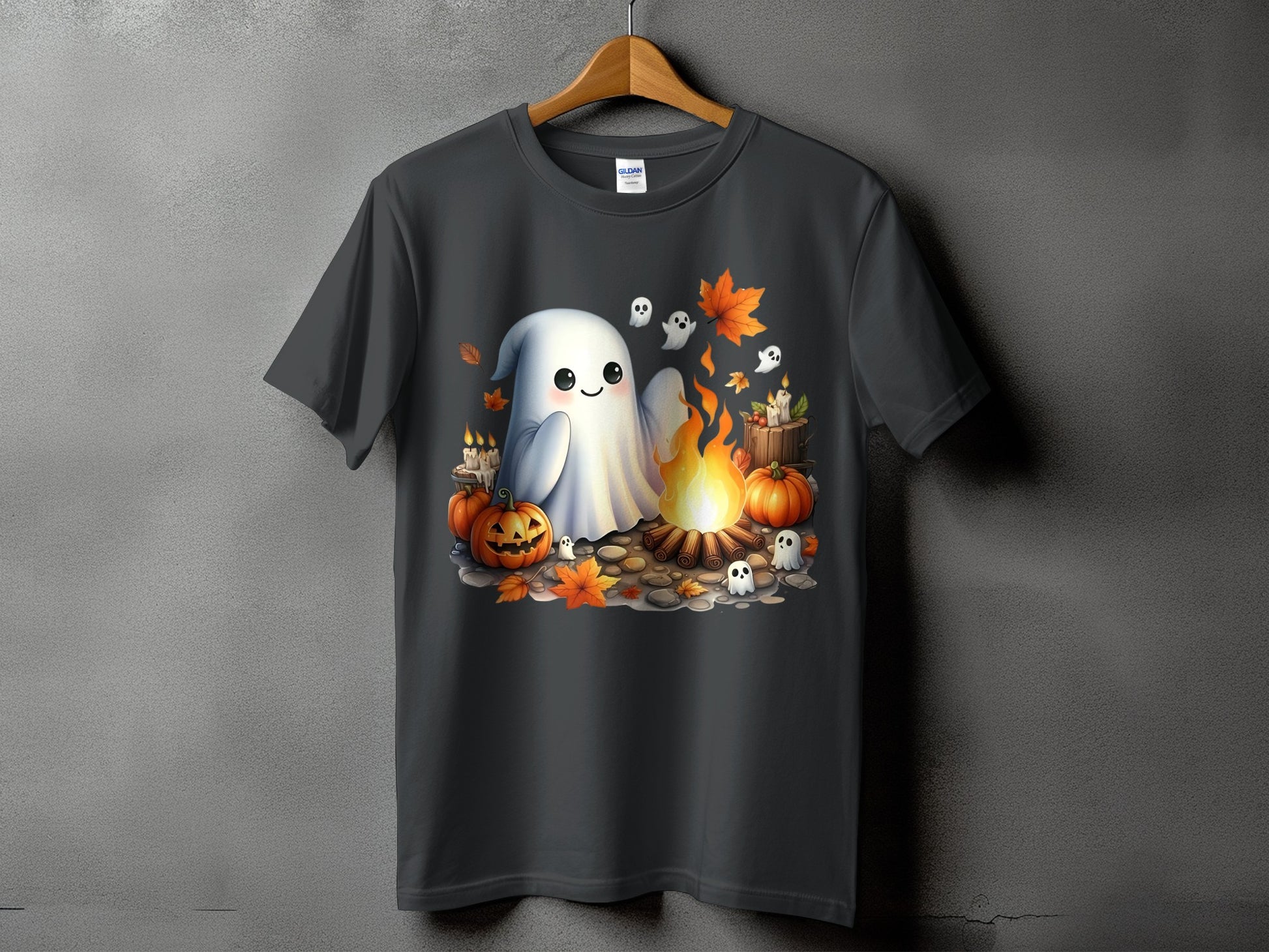 Cute ghost, pumpkins, and campfire Halloween graphic on a dark t-shirt.