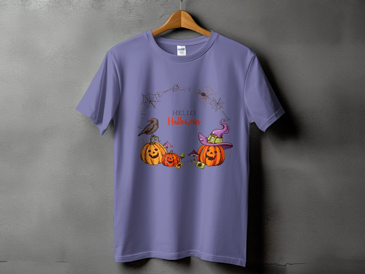 Purple t-shirt with Halloween graphic of pumpkins, crow, witch hat, spiders and text "HELLO Halloween".