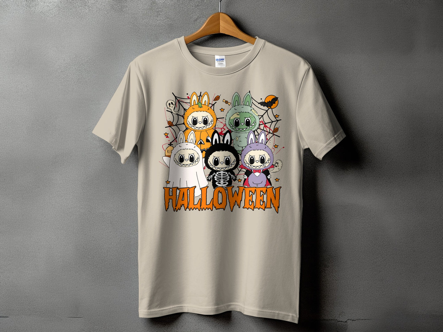 T-shirt with cartoon Halloween characters dressed as ghosts, vampires, skeletons, and pumpkins.
